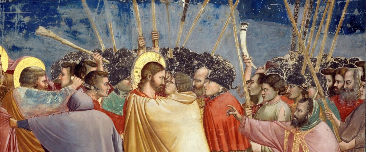 Fresque de Giotto : Judas, vêtu d'un manteau jaune, enlace Jésus pour l'embrasser au milieu des soldats et des torches