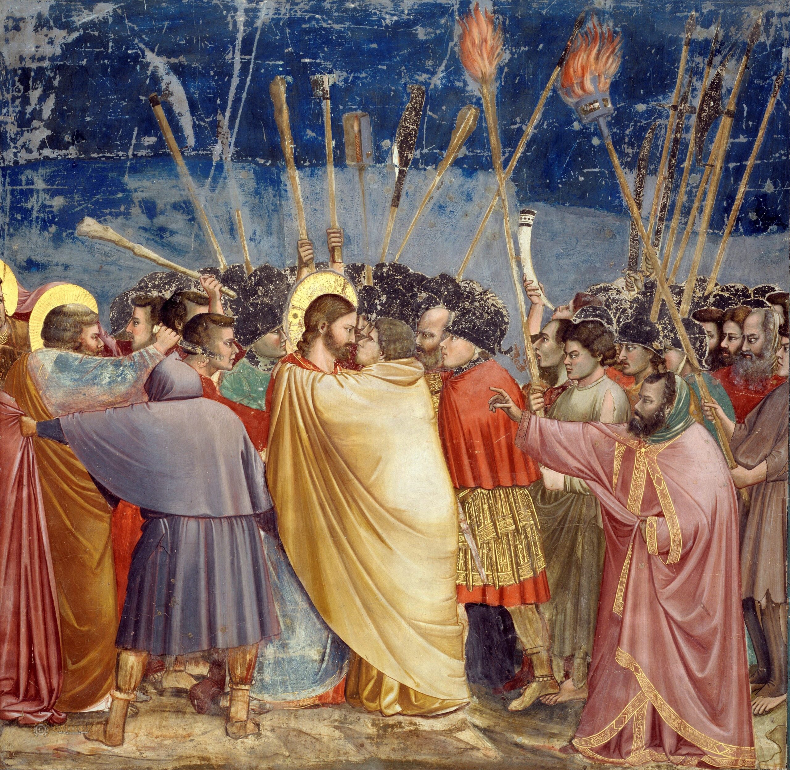 Fresque de Giotto : Judas, vêtu d'un manteau jaune, enlace Jésus pour l'embrasser au milieu des soldats et des torches